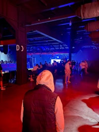 a group of people standing in a dark room